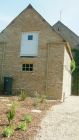 Rebuilding of crumbling gable end on old stone barn using existing stone